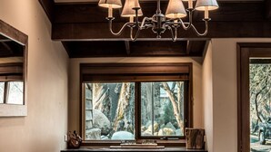 A room with a large window, a chandelier, and a wooden ceiling. - Bundaleer - Woodridge (Woodridge)