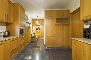 A modern kitchen with wooden cabinets, stainless steel appliances, and a granite countertop. - Charming Villa Viana do Castelo (Viana do Castelo)
