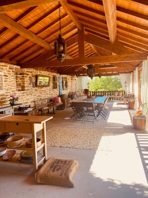 A rustic wooden interior with stone walls, a wooden table, and a bench. - Casa Gelasio Private Pool (Tondela)