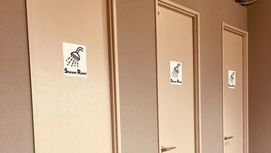 A row of four doors with "Shower Room" signs, each with a showerhead icon. - Mikami Asakusabashi Hotel (Tokyo)
