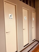 A row of four doors with "Shower Room" signs, each with a showerhead icon.