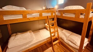 A bunk bed room with a ladder, wooden floors, and a window with natural light. - Mikami Asakusabashi Hotel (Tokyo)