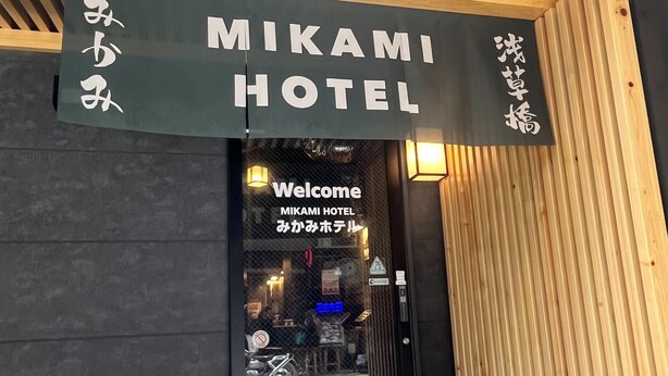 The entrance to Mikami Hotel with a wooden facade and a welcoming sign. - Mikami Asakusabashi Hotel (Tokyo)