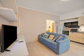 Family Apartment, Multiple Bedrooms (Riva Nest) | Living area | 21-inch TV with cable channels