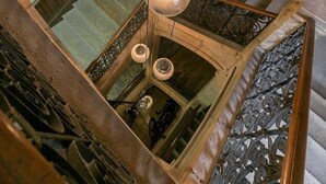 A grand staircase with ornate metal railings and a circular viewing platform. - Le Bressey  Historic Mansion (Dijon)