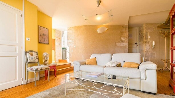 A living room with a white sofa, a coffee table, and a red chair. - Le Panoramique - Exceptional View (Dijon)