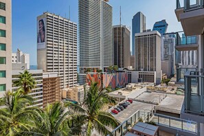 A high-rise building with a prominent advertisement on its side. - Best Stay Gym Bar Spa (Miami)