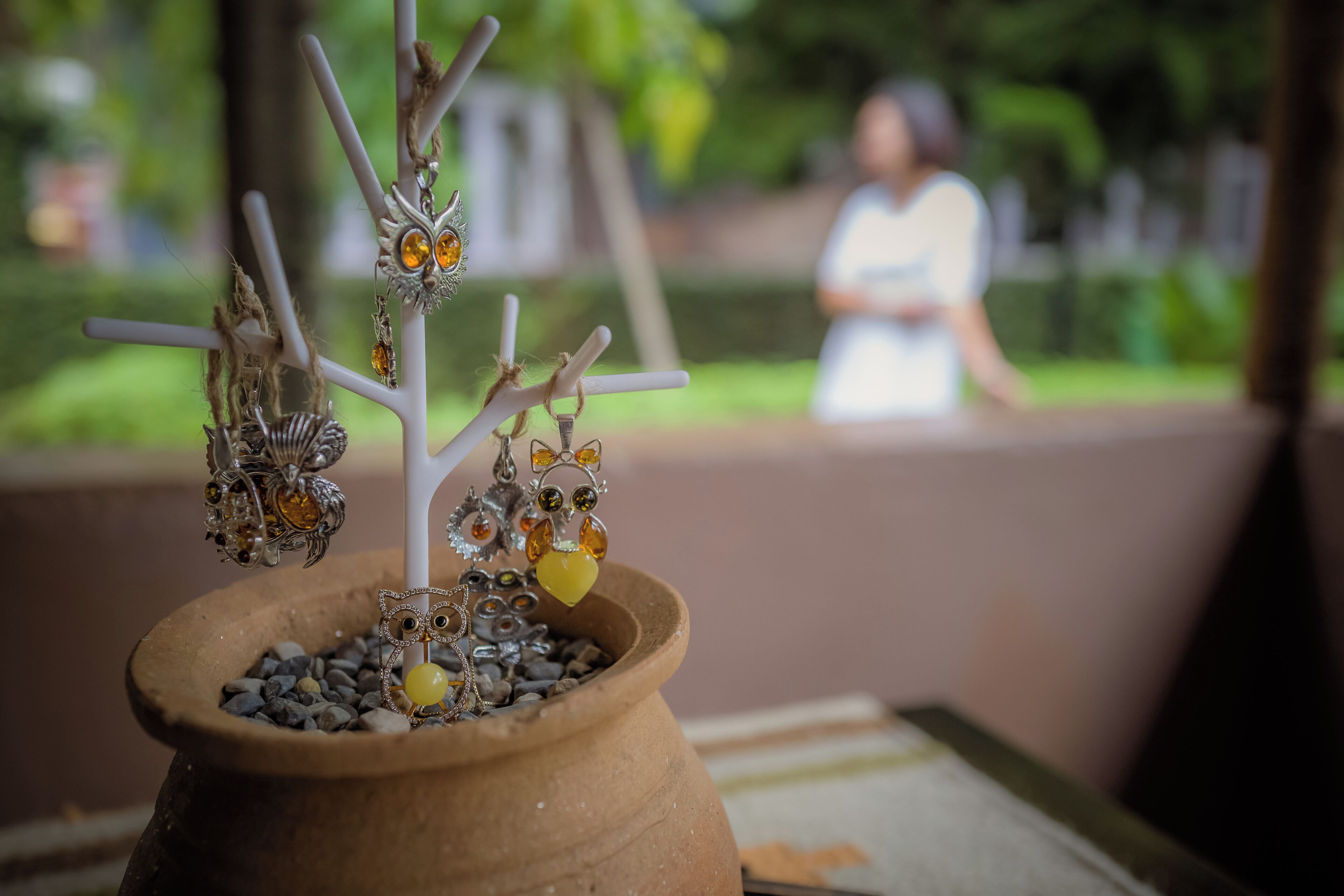 A potted plant with decorative branches and ornaments.