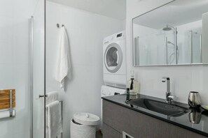 Shower, hair dryer, towels, toilet paper