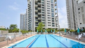 A swimming pool surrounded by high-rise residential buildings.
