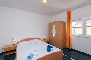 Relax in a serene space with a single bed, bedside tables, and a wardrobe with mirror.