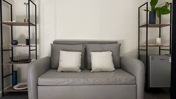 Superior Studio Suite, Courtyard View | Living area | TV