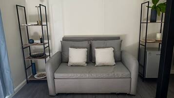 Superior Studio Suite, Courtyard View | Living area | TV