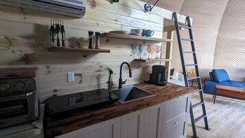 Fridge, microwave, coffee/tea maker, cookware/dishes/utensils