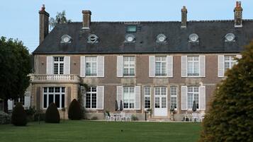 A large, historic building with multiple windows and a symmetrical facade.