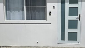 A white building with a window and a door. - Sea Breeze Tunnel Hideaway 6 (Terranova)