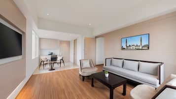 Suite Deluxe, 1 cama de matrimonio grande | Zona de estar | Televisión LED de 43 pulgadas con canales por satélite