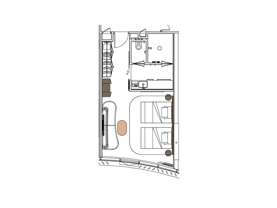 A floor plan of a hotel room with a bathroom, kitchenette, and a seating area.