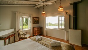 A bedroom with a bed, a chair, a dresser, and a ceiling fan. - FLH Belaventura Villa (Boliqueime)