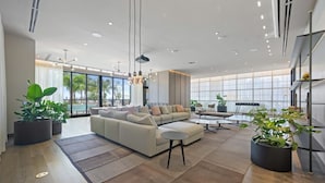 Una sala de estar moderna con un sofá seccional, una mesa de centro y plantas en macetas.