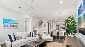 A modern living room with a sofa, coffee table, and dining area. - Free Shuttle to Beach, 3 Bedrooms Plus Loft, 30A Grayton Beach, Pool, Bikes (Santa Rosa Beach)