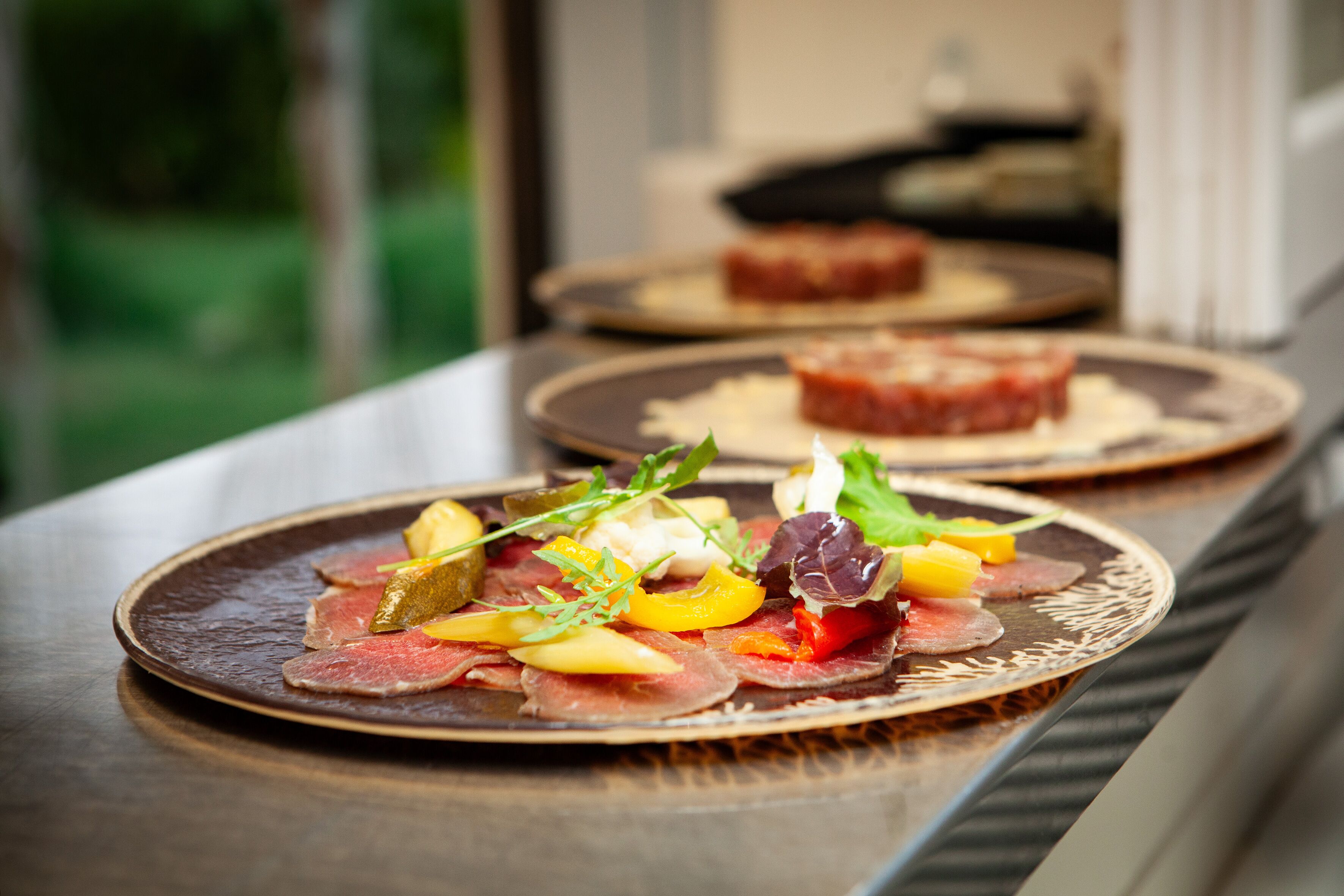 A dining table with plates of food.