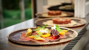 A dining table with plates of food.
