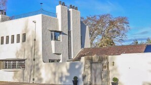 Un bâtiment moderne doté d’un toit plat, d’une grande fenêtre et d’une petite porte.