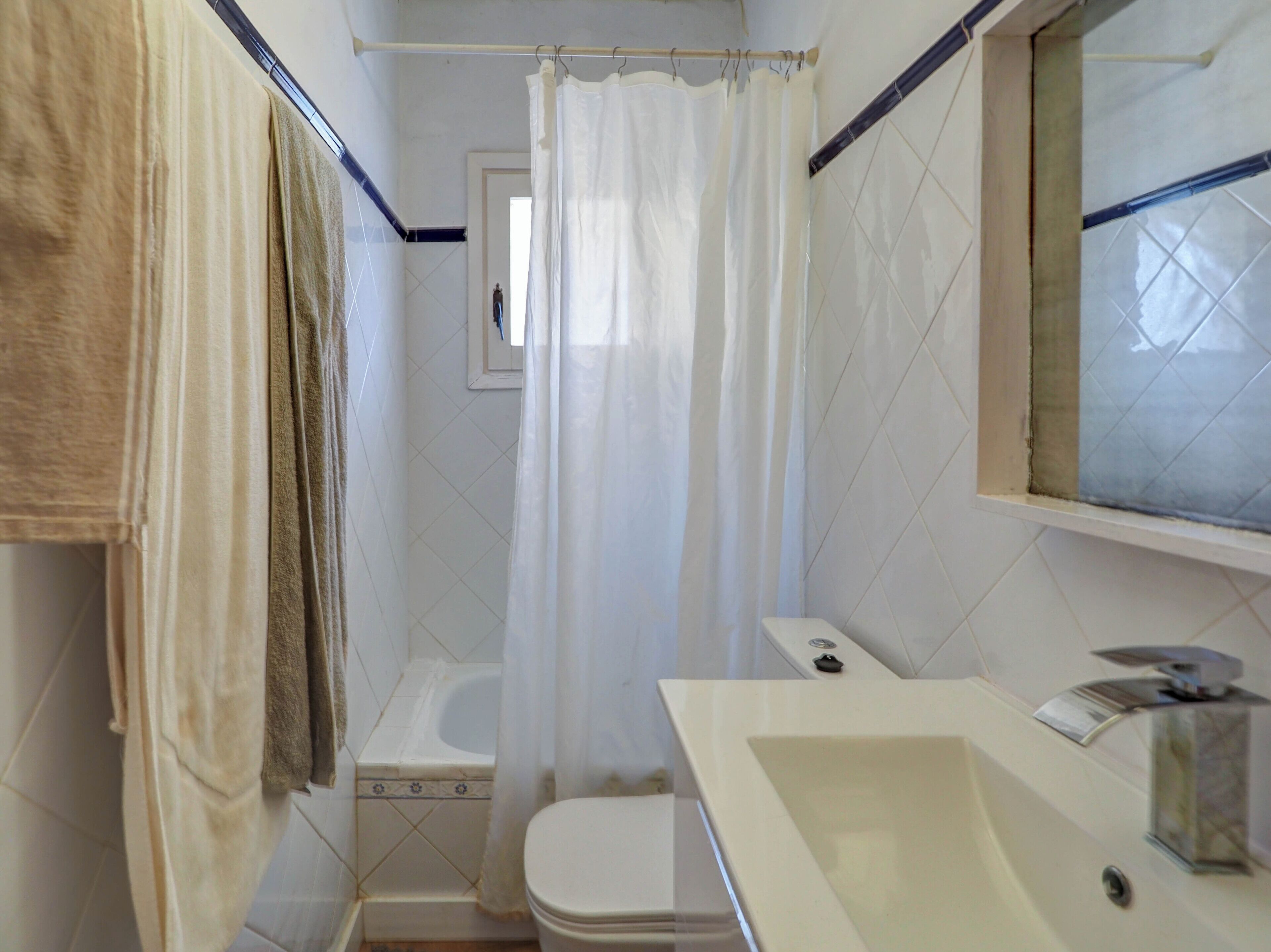 Un baño con bañera, inodoro y lavabo.