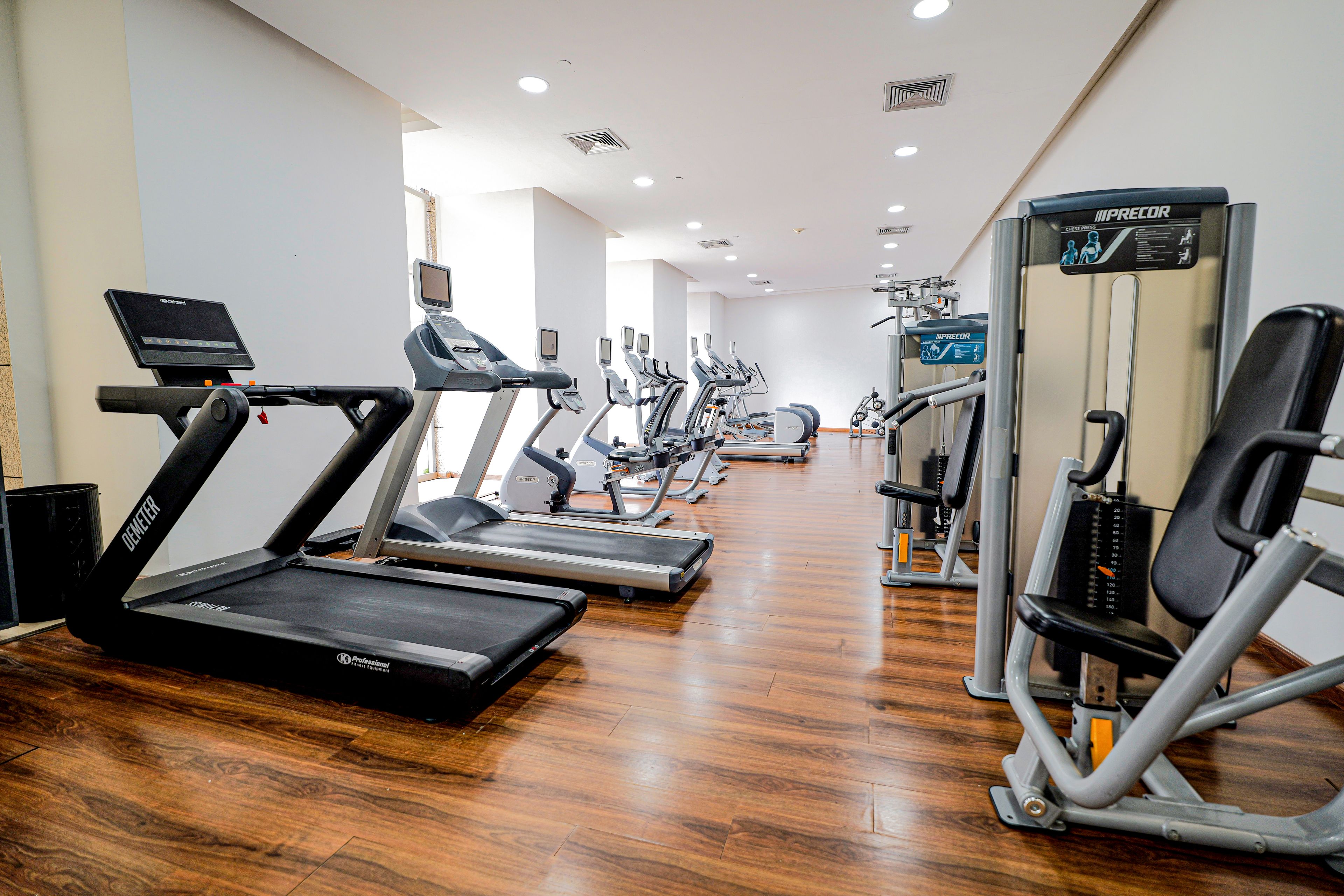 A gym with treadmills, elliptical machines, and weight equipment.