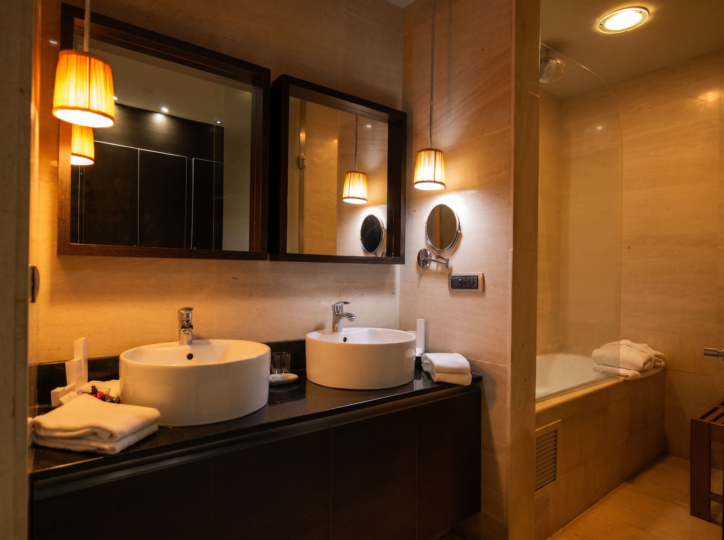 A modern bathroom with two sinks, a large mirror, and a bathtub.
