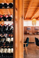 A wooden interior with wine racks and a bar area.