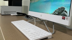 A desktop computer with a mountain lake wallpaper, a keyboard, and a mouse on a beige desk. - 1st Place at Wesley (Decatur)