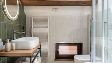 A modern bathroom with a freestanding sink, a built-in window, and a glass shower enclosure.