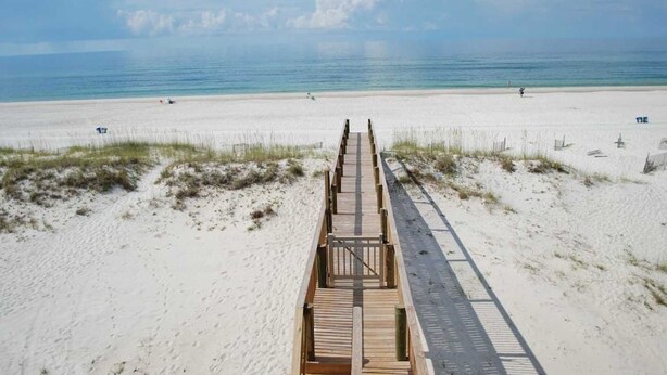A wooden boardwalk leading to a beach with clear skies and calm waters. - Beachfront 8bedrooms Lemonshello (Gulf Shores)