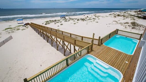 A beachside property with a wooden deck, two hot tubs, and a view of the ocean. - Beachfront 18bed Pool Easybreezy (Gulf Shores)