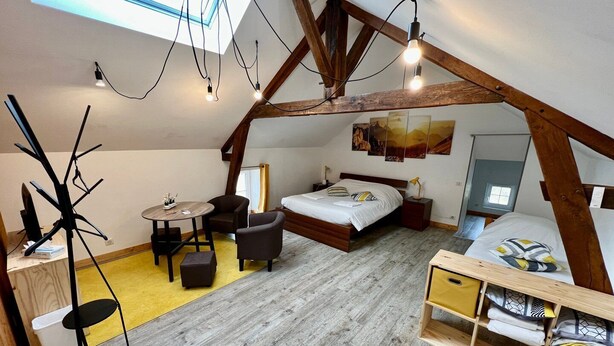 A bedroom with a loft-style ceiling, a bed, a desk, and a chair. - Charming 3 bedroom house (Lussac-les-Châteaux)