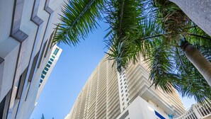 A high-rise hotel with a modern architectural design, featuring a prominent facade with horizontal lines and a series of balconies. - Perfectly Located Miami 3BR with Stunning Views (Miami)