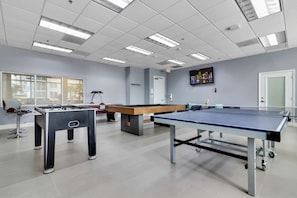 A modern indoor recreational area with a foosball table, pool table, and ping pong table. - Perfectly Located Miami 3BR with Stunning Views (Miami)