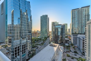 A cityscape with modern high-rise buildings, including a distinctive glass structure and a tall, cylindrical building. - Perfectly Located Miami 3BR with Stunning Views (Miami)