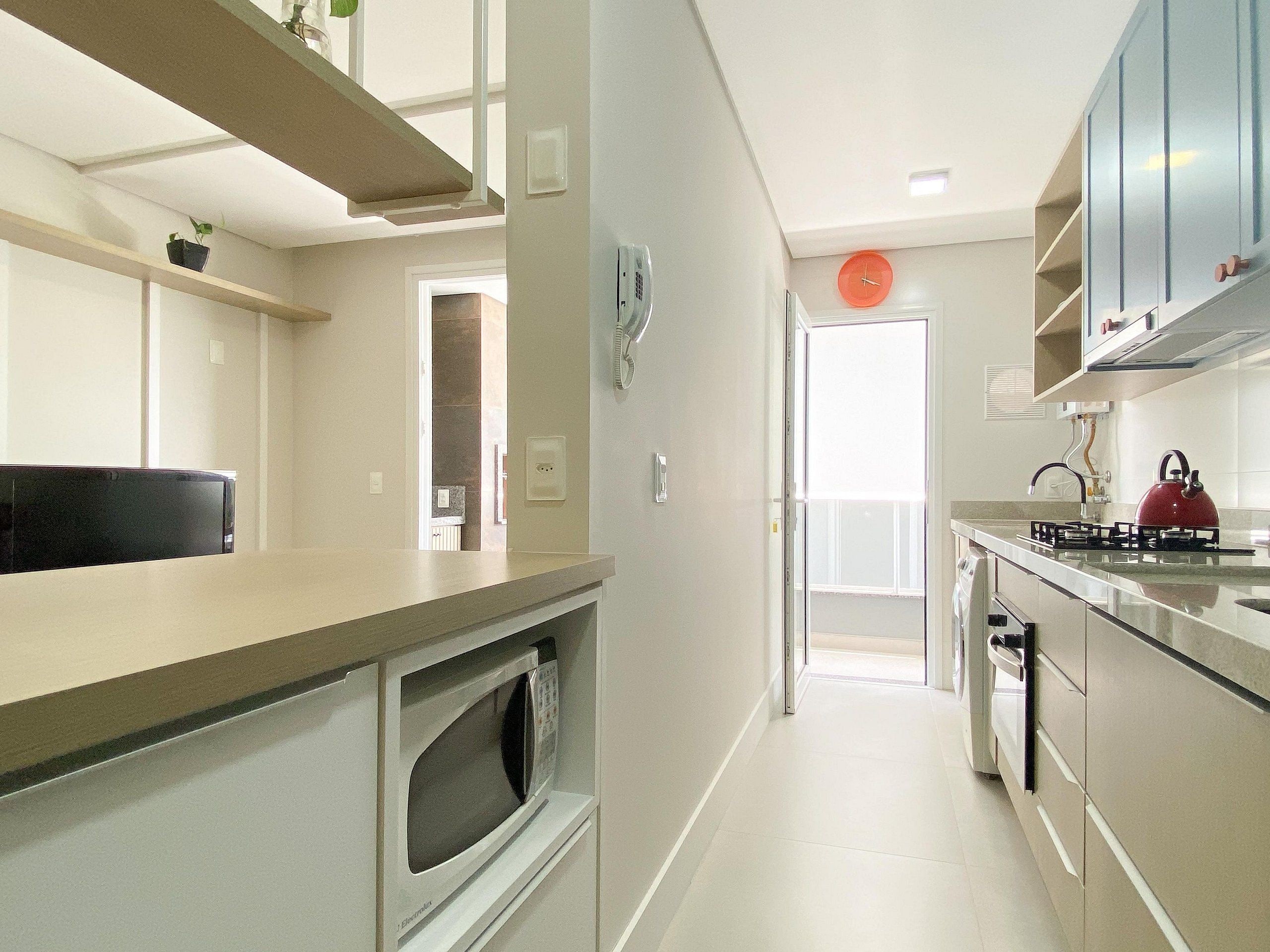 A modern kitchen with a microwave, stove, and cabinets.