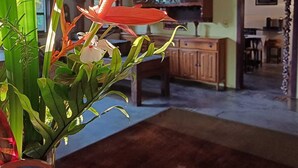 A room with a wooden ceiling, a wooden cabinet, and a large window. - Pousada do Pequi (Serro)
