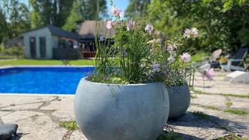 Seasonal outdoor pool, open 10:00 AM to 7:00 PM, pool umbrellas