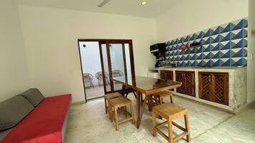 Deluxe Suite, Patio, Courtyard View | Living area | TV