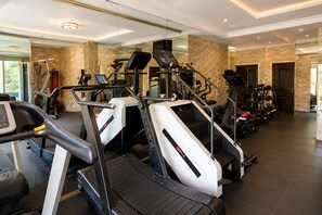 A modern gym with treadmills, ellipticals, and weight machines. - Grand Bohabs (Abuja)