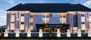 A large, multi-story hotel with a prominent 'Grand Bohabs' sign, featuring a classic architectural style with symmetrical windows and a central entrance. - Grand Bohabs (Abuja)