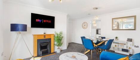 TV, fireplace, books