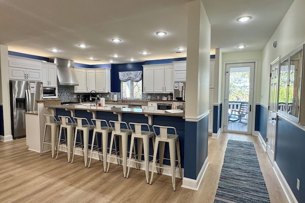 well appointed kitchen with seating at the bar/island