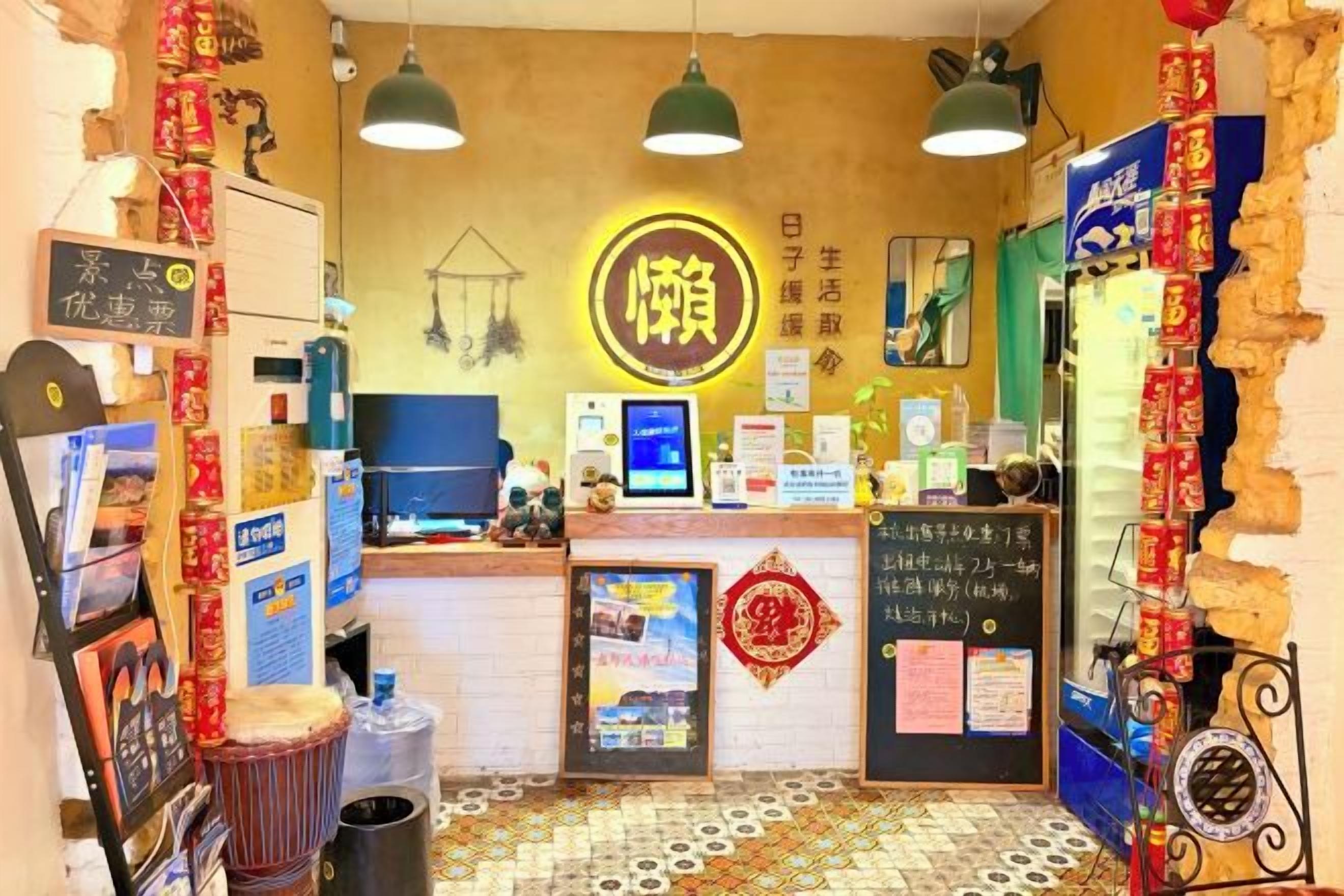 A restaurant interior with a counter, hanging lights, and various decorations.