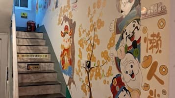 A staircase with a mural featuring cartoon characters and Chinese characters.